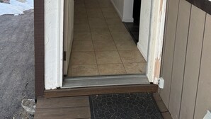 A house number 1308, a wooden bench, a wall-mounted light fixture, and a door leading inside. - NORTH LAKE TAHOE VACATION RENTAL WITH SKI AND MOUNTAIN VIEWS, HIKE & BIKE TRAILS (Incline Village)
