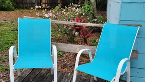 Two turquoise chairs with white frames on a wooden deck. - Charming Fruitland Park Getaway (Fruitland Park)