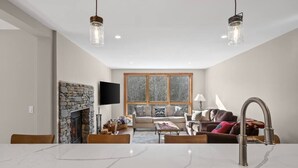A modern kitchen with a marble countertop and a stainless steel sink. - Spacious 3 Level 3BR+3Bath Townhouse w/Fireplace (Dover)