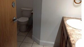 A bathroom with a toilet, a sink, and a 'Live long love' sign on the wall. - North Getaway Cottage (Williamstown)