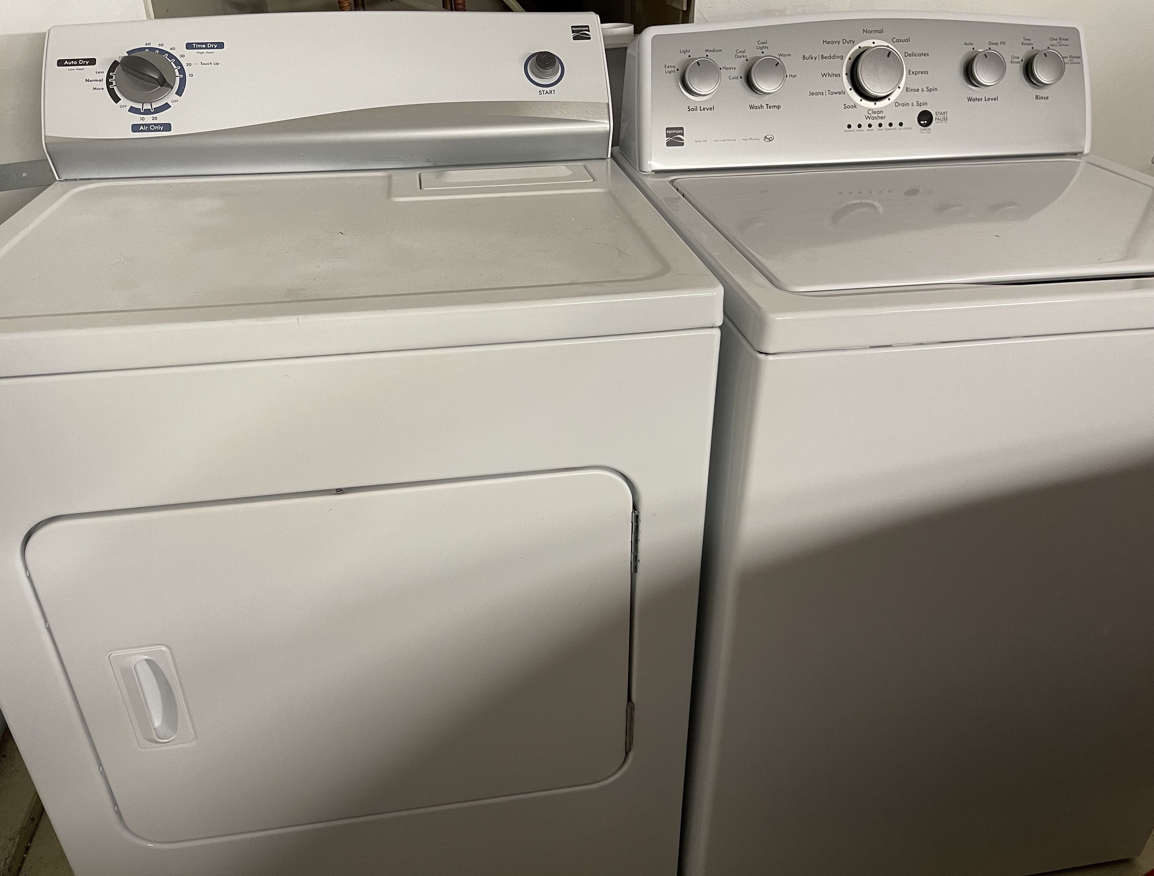 Two front-loading washing machines with control panels.