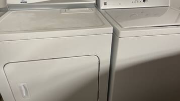 Two front-loading washing machines with control panels.