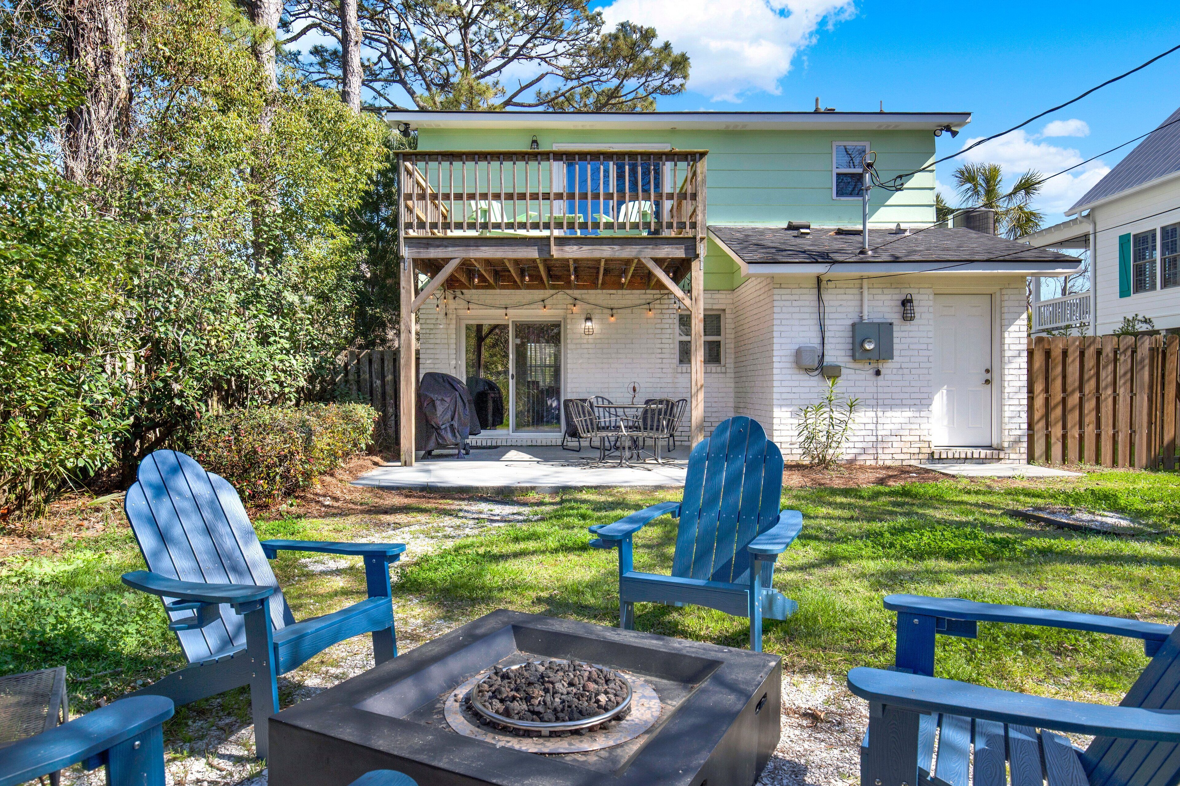 A house with a covered patio, outdoor seating, and a fire pit.