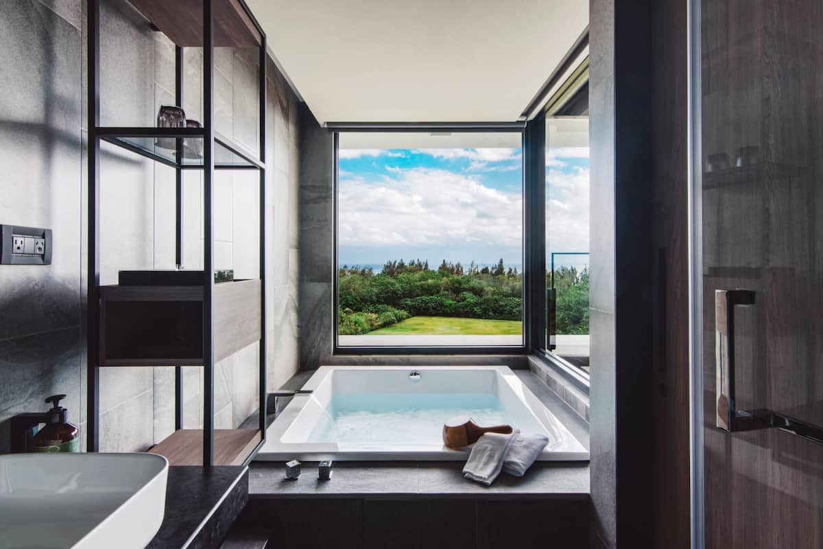 building tranquil - executive deluxe junior suite with ocean view | bathroom | separate bathtub and shower, rainfall showerhead, hair dryer, slippers