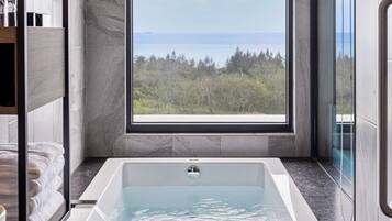 Separate tub and shower, rainfall showerhead, hair dryer, slippers