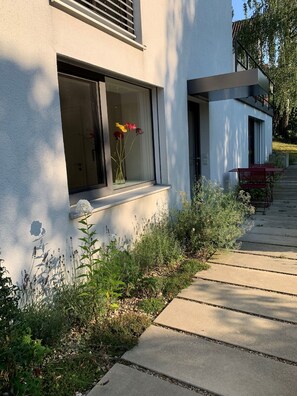 A modern building with a large window displaying flowers.
