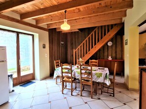 Enjoy meals in this dining area with a table for four, surrounded by comfortable chairs.