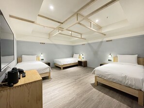 A hotel room with three beds, wooden headboards, and bedside tables with lamps. - Green Hotel - midori (Taichung)