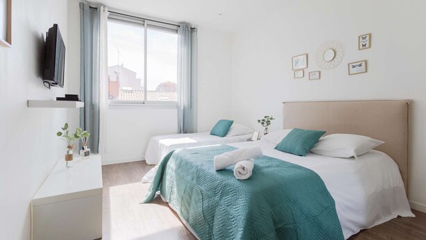 A modern hotel room with two beds, a TV, a desk, and a window with curtains. - MaisonMars Studio 5 Blancarde (Marseille)