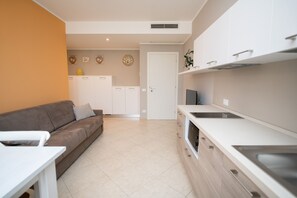 Comfort Apartment, 1 Bedroom (Gerbera) | Living area | 50-inch TV with cable channels