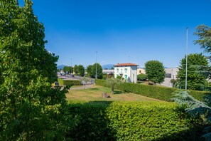 A landscaped area with a building, trees, and a clear sky.