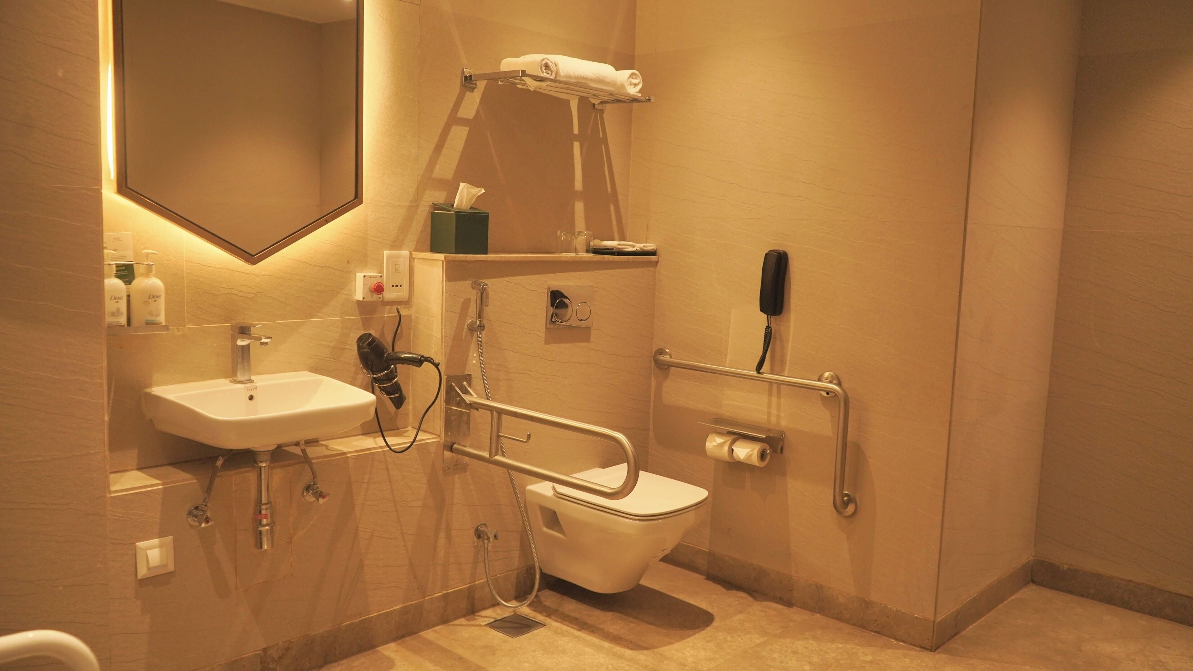 A bathroom with a sink, toilet, and a shower area.