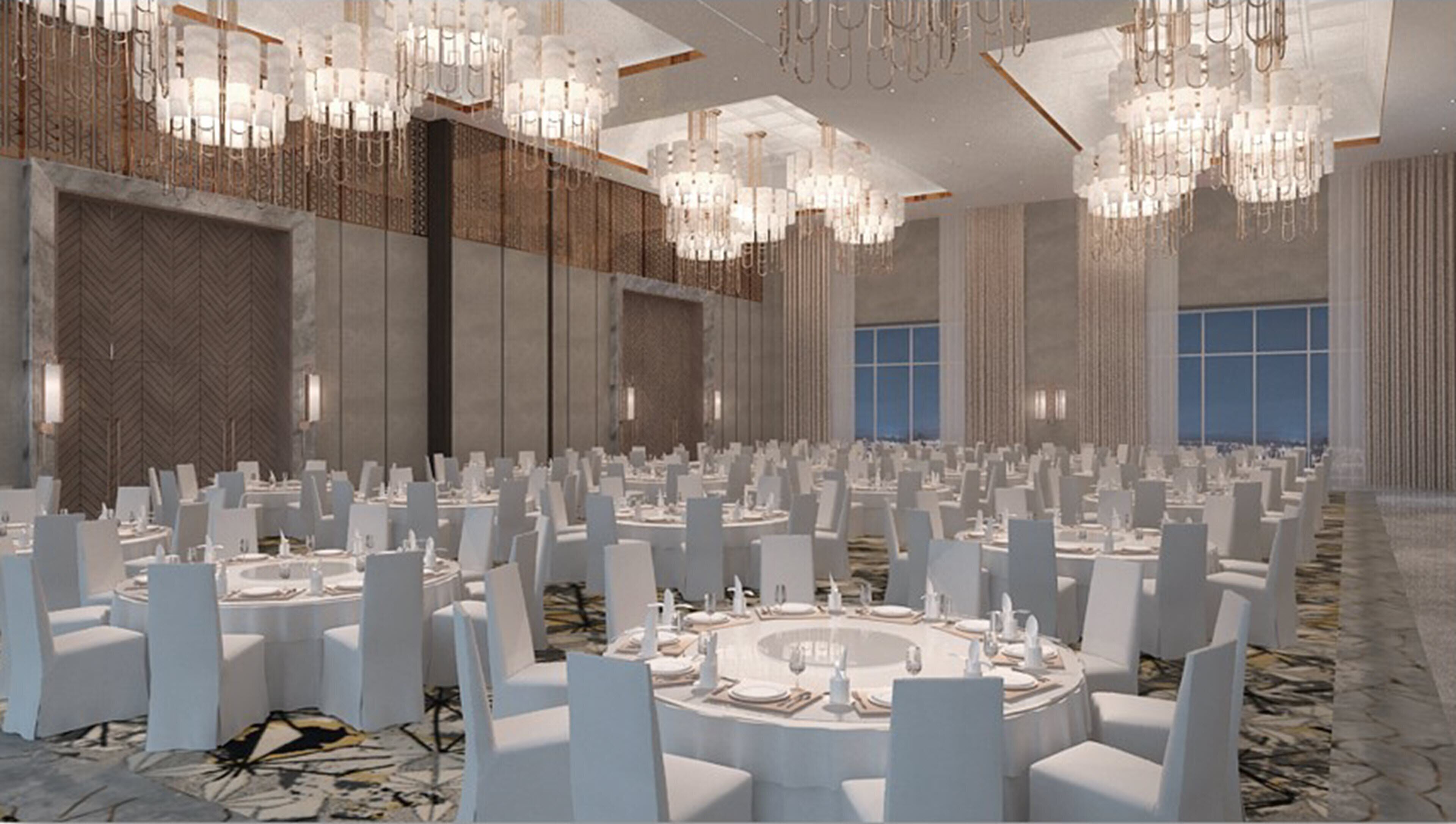 A large banquet hall with round tables, white chairs, and chandeliers.