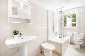 Combined shower/bathtub, hair dryer, towels, toilet paper