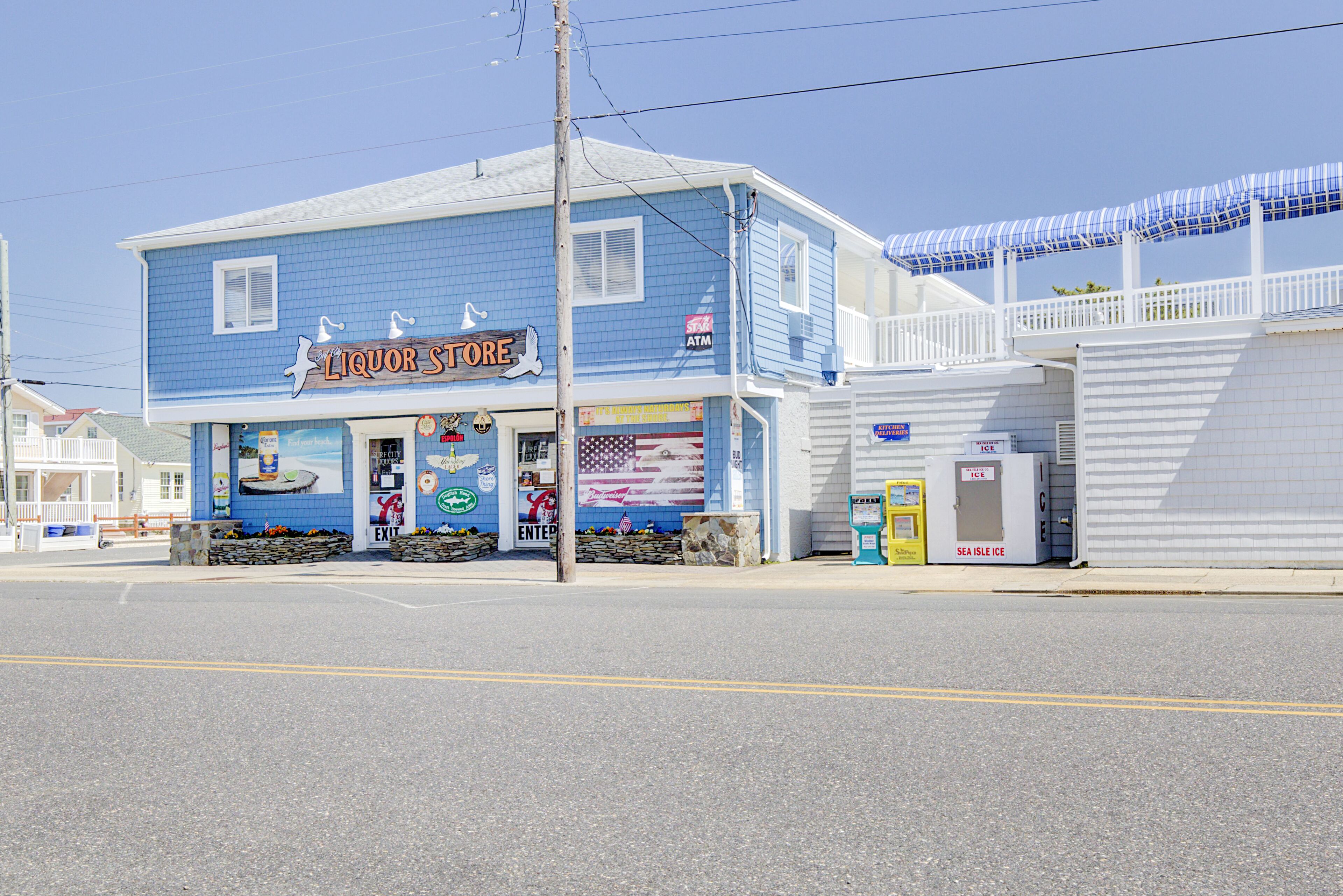 A two-story building with a sign reading "Liquor Store" and an American flag mural.