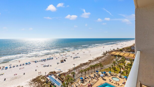 A beach resort with a pool, sun loungers, and a view of the ocean. - The Summit 1121 (Panama City Beach)