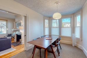 Enjoy a warm and inviting space with a large dining table, comfortable chairs, and a fireplace.