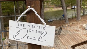 A wooden deck with a sign that reads "Life is better on the deck."