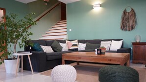 A living room with a sectional sofa, a coffee table, and a potted plant. - Family villa between sea and scrubland 15 min Mtp (Combaillaux)
