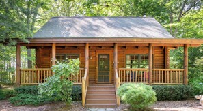A wooden cabin with a porch, number 3580, surrounded by trees. - Wander Inn - Updated Log Cabin near shared beach (Saugatuck)