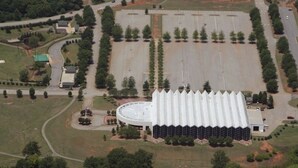 An aerial view of a large, circular building with a central dome and a surrounding parking lot. -  EZ - GO Lodging 3.7 mi Green Pond Landing(Lake Hartwell) Clemson Univ 15 mil. (Anderson)