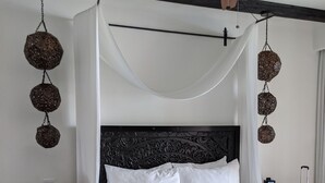 A neatly made bed with white linens, a dark wooden headboard, and a ceiling fan. - 2 Bedroom Serenity Pool View (San José del Cabo)
