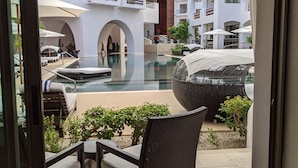 A modern hotel courtyard with a pool, outdoor seating, and a view of the building's architecture. - 2 Bedroom Serenity Pool View (San José del Cabo)