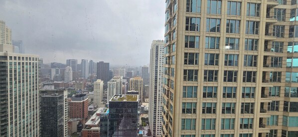 A high-rise building with a grid of windows and balconies. - Luxury 1BR Condo – Views, Comfort, & Style (Chicago)