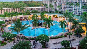 A hotel with multiple swimming pools, palm trees, and a mountainous backdrop. - 1 BR Ocean Front at Marriott Kauai (Kauai)