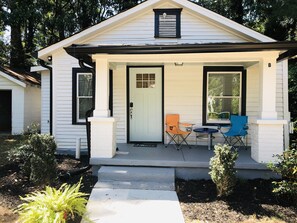 A small white house with a front porch, a door, and two windows. - Secluded 1Bdrm Cottage .Free Wifi with Netflix 15 min Airport Near Stadium (Atlanta)