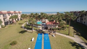 A resort with a pool, palm trees, and a view of the beach. - Ocean Village Club I33, Elevator, 2 Pools (1 Heated) Ocean View (St. Augustine)