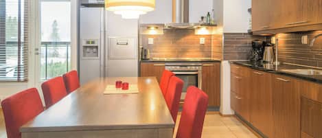 A modern kitchen with a dining area.