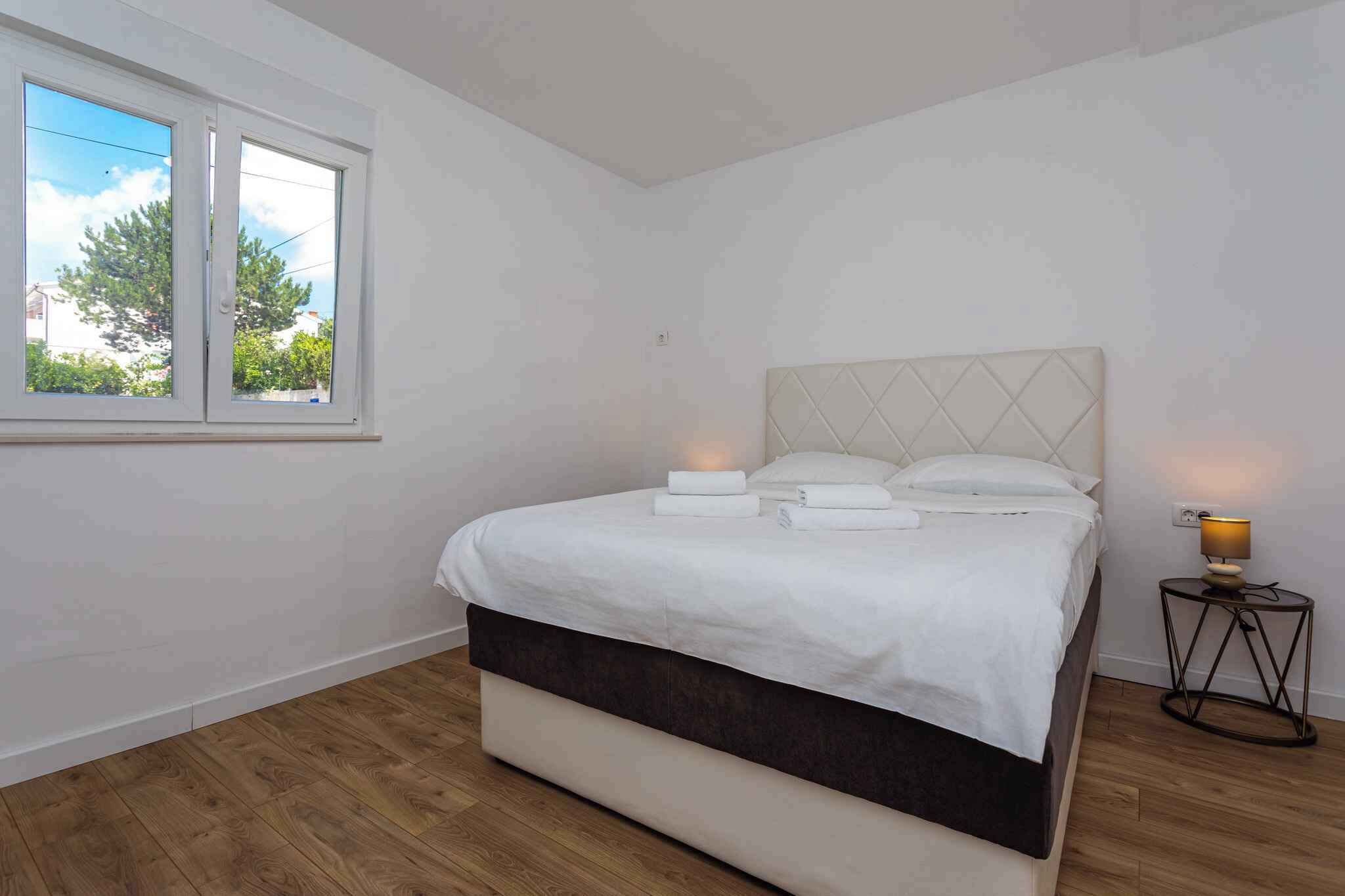 A bedroom with a bed, a window, and a bedside lamp.