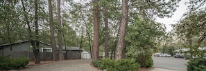 Set amidst tall trees, this single-story house offers a yard and a garage.