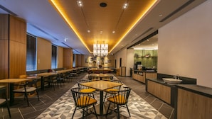 A modern restaurant with a geometric patterned floor, wooden ceiling, and a central dining area with round tables and chairs. - Hotel Forza Osaka Namba Dotonbori (Osaka)