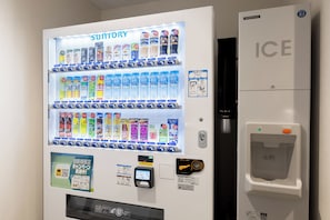 A vending machine with various beverages and a water dispenser.