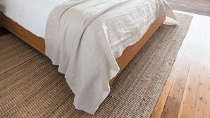 A bedroom with a bed, a window, a plant, and a view of the outdoors. - Crystal Pacific Palm Beach (Palm Beach)