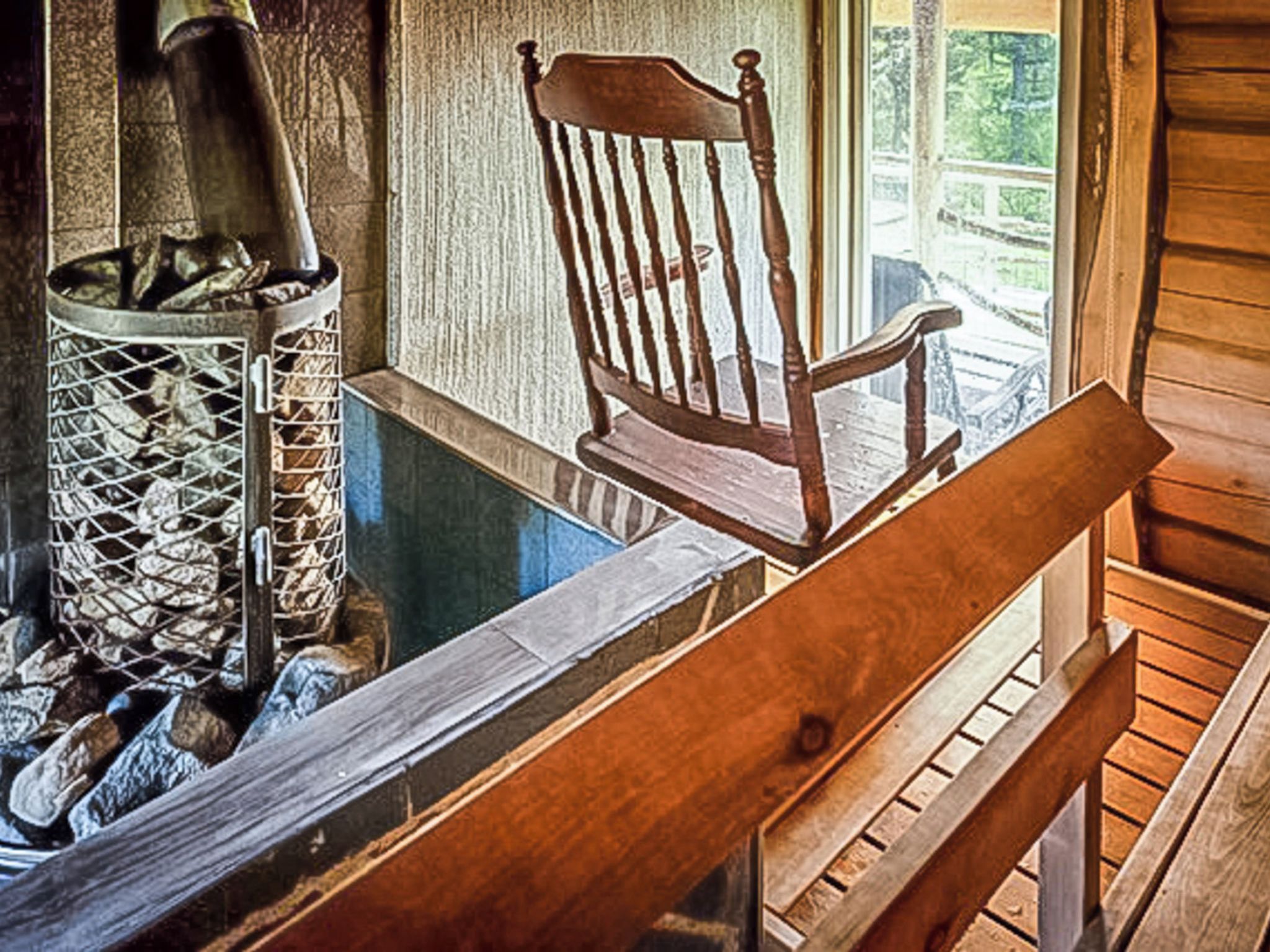 A wooden bench and a metal fireplace with logs.