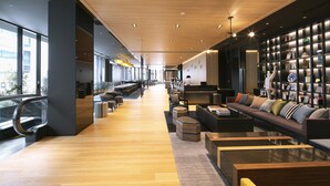 A spacious lobby with a long counter, seating area, and a bookshelf. - Hotel Intergate Osaka Umeda (Osaka)