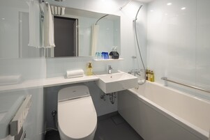 Un baño moderno con inodoro, lavamanos y bañera.