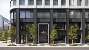A modern hotel building with a curved facade, large windows, and a prominent entrance. - Hotel Intergate Osaka Umeda (Osaka)
