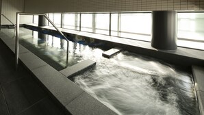 A modern indoor pool with clear water, metal railings, and a view of the sky through large windows. - Hotel Intergate Osaka Umeda (Osaka)