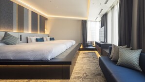 A modern hotel room with a large bed, a sofa, a desk, and a large window with curtains. - Hotel Intergate Osaka Umeda (Osaka)