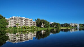 A multi-story hotel with balconies, a calm lake, and a fountain. - 2 BR at Marriott Cypress Harbour (Orlando)