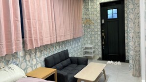 A room with a sofa, a small table, a bed, a wardrobe, and a door. - Platinum Yasaka (Kyoto)