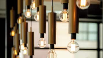 A series of hanging pendant lights with exposed bulbs in a modern interior setting.