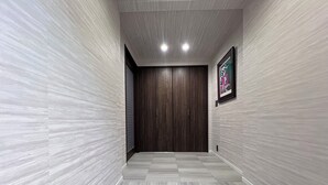 A hallway with a checkered floor, wooden doors, and a framed picture on the wall. - Platinum Kiyomizu (Kyoto)