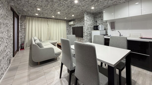 A modern kitchen with white cabinets, a microwave, and a sink. - Platinum Kiyomizu (Kyoto)