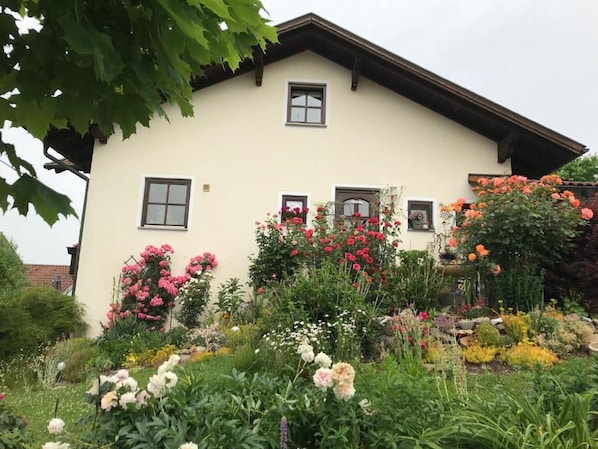 A two-story house with a garden in front.