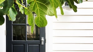 A black front door with a glass panel and a doorbell. - Castlebar - Superior Boutique Accomodation - Steps to Pakington Street (Geelong West)